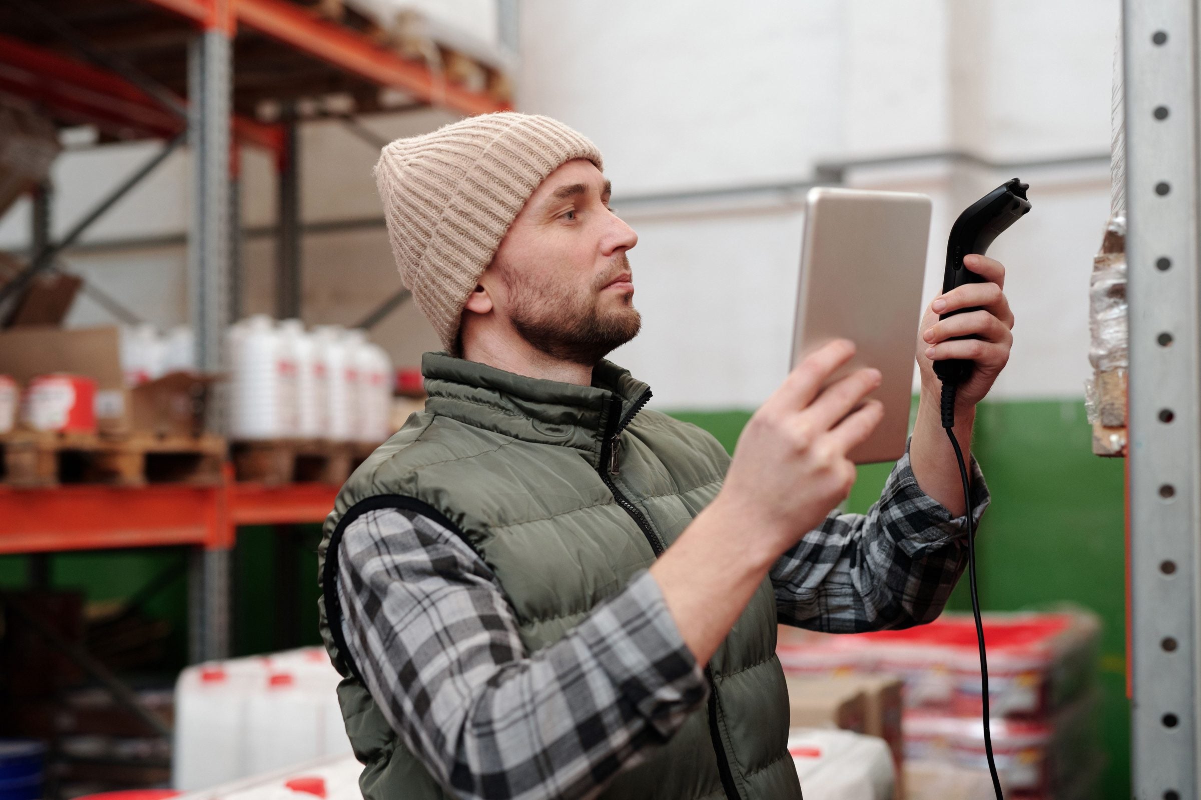 Warehouse worker scanning inventory with a tablet
