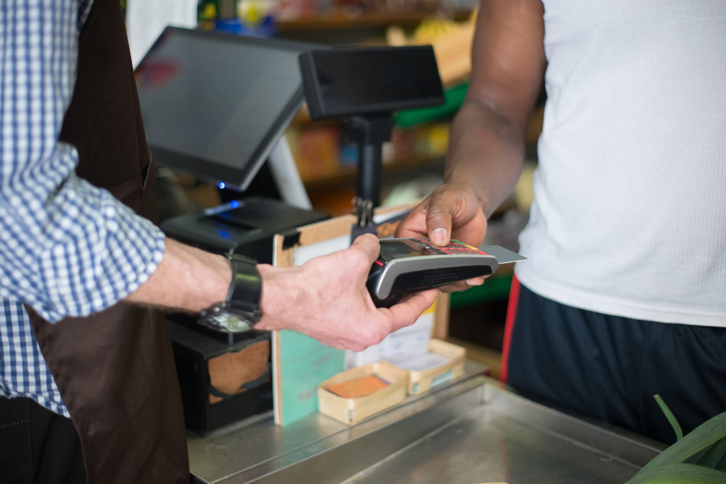 Customer completing a card payment at an unbranded checkout